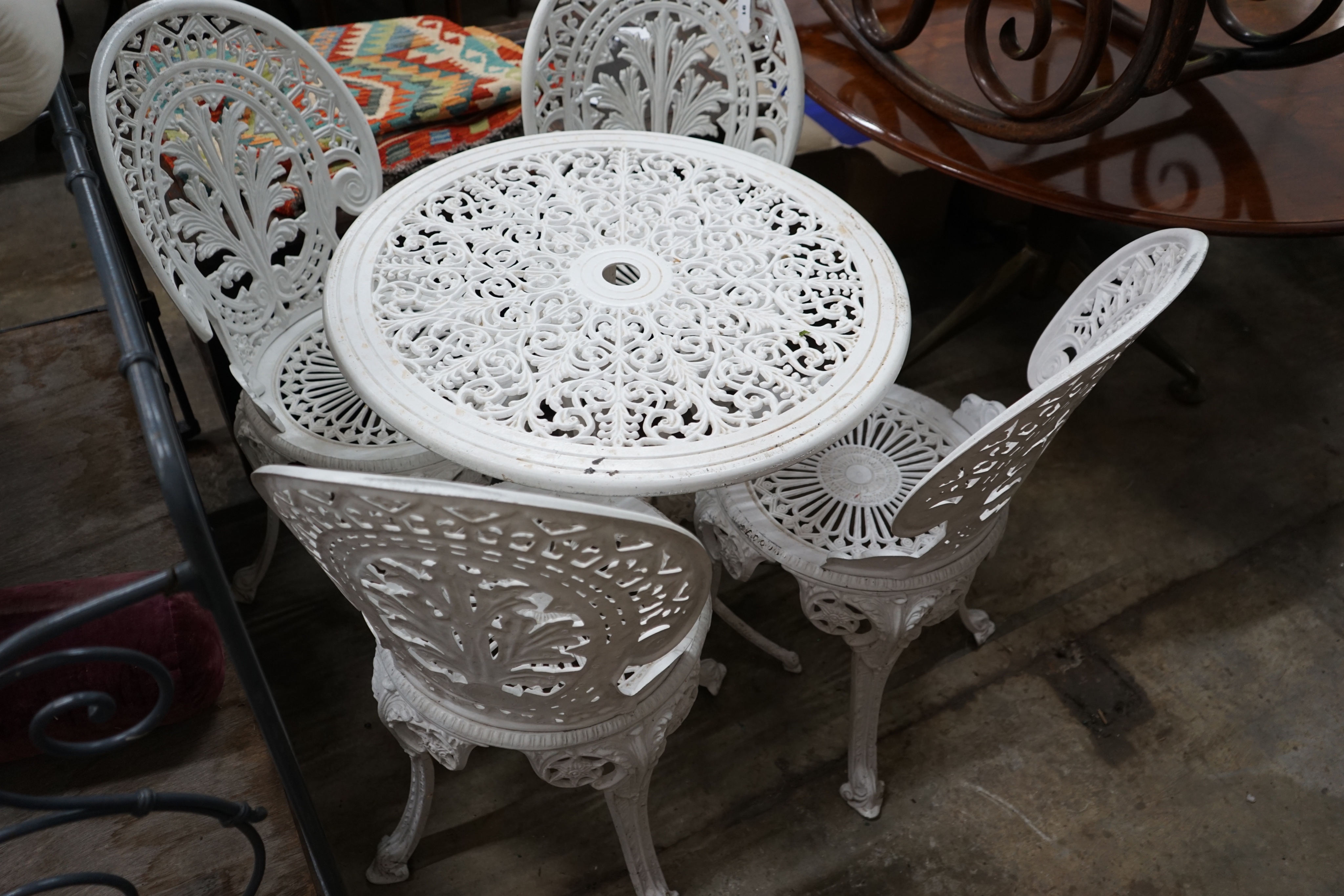 A Victorian style painted aluminium garden table and four chairs, table diameter 68cm height 65cm